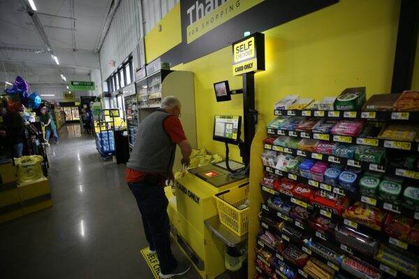 A man uses the self-checkout at Dollar General.